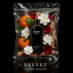 Velvet perfume bottle with flowers and oranges in a clear packaging on a black background